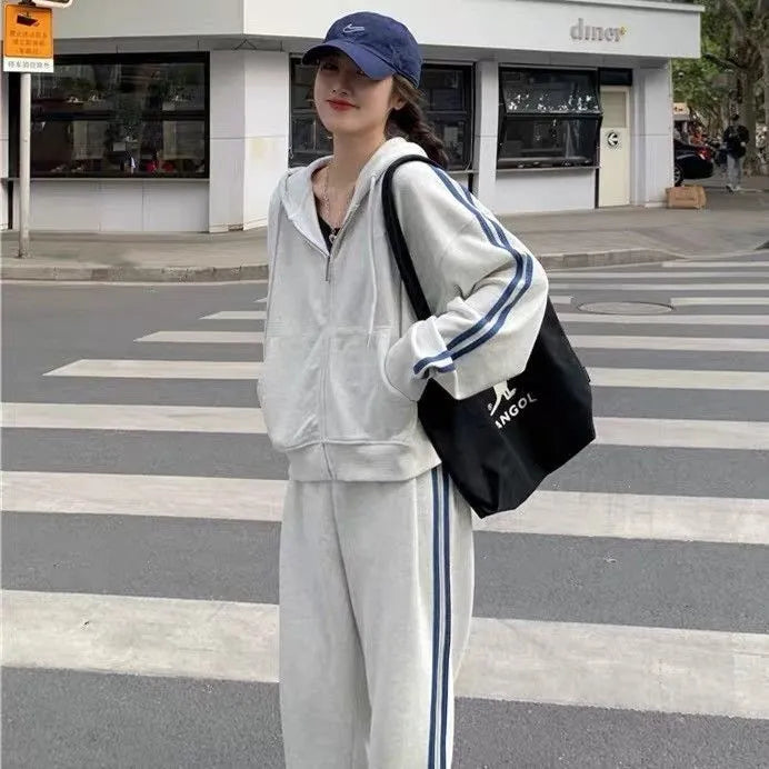 Women's two-piece striped polyester tracksuit set, light gray, top and trousers on plain background
