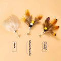 Three steel wire cat toy replacement heads with small flying insect designs on a white background.