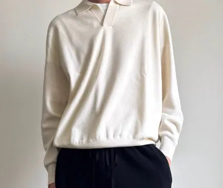 Man wearing a milky white pure wool polo sweater with a lapel collar and loose fit.