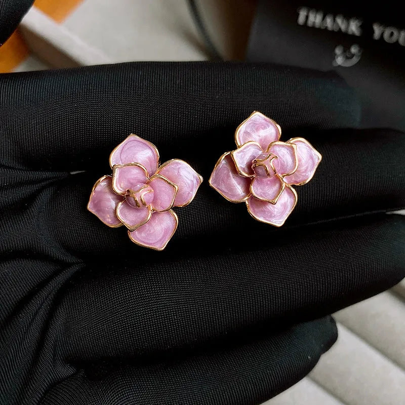 Golden-purple oil-spot glaze flower stud earrings on a copper base with surgical steel posts.