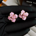 Golden-purple oil-spot glaze flower stud earrings on a copper base with surgical steel posts.