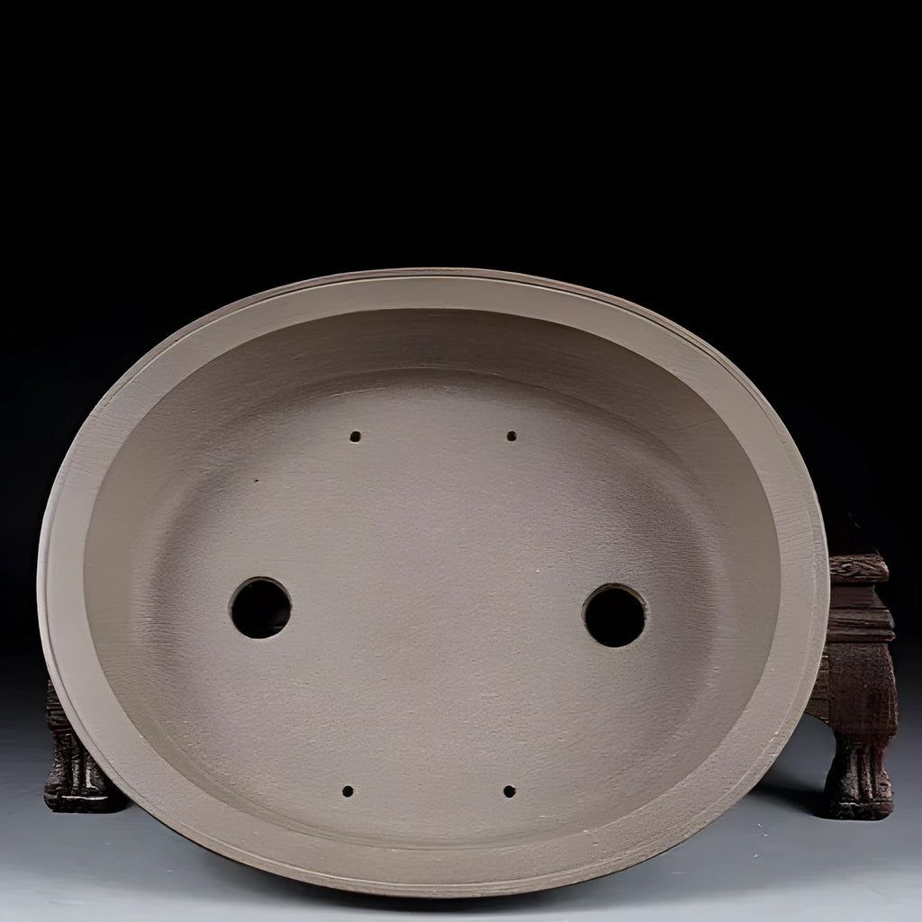 Handmade antique oval bonsai flower pot made from purple sand clay, dimensions 25x21x6.3 cm.