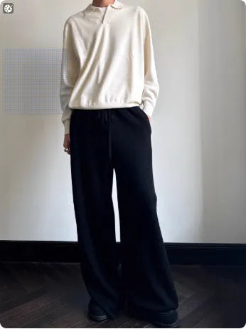 Man wearing a milky white pure wool polo sweater with a lapel collar and loose fit.