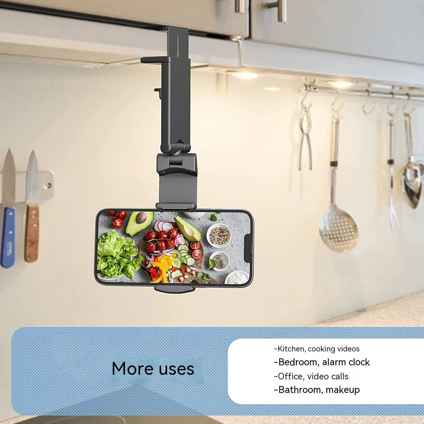 Foldable rotating universal phone holder in black on a desk next to a mobile phone.