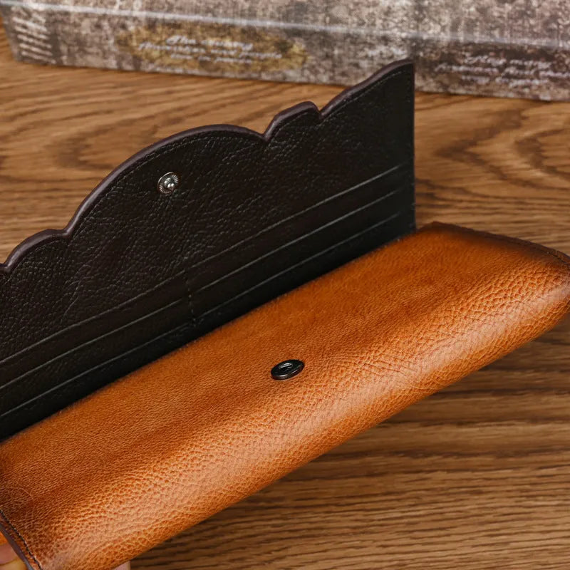 Retro brown tri-fold leather wallet with embossed floral pattern, shown open to reveal multiple card slots and compartments.
