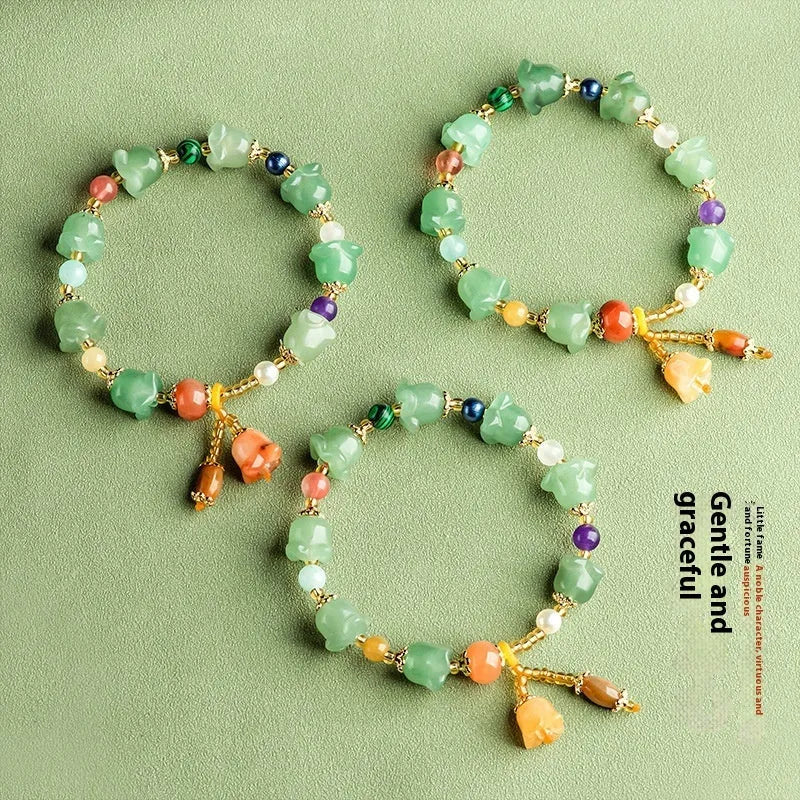 Natural Xinjiang Jinsi Jade bracelet with carved orchid beads in aventurine orchid colour.