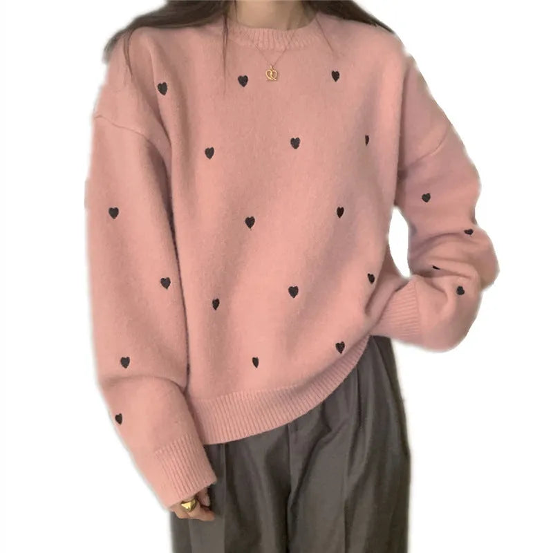 Women's loose cream pullover sweater with embroidered red love pattern on the front.