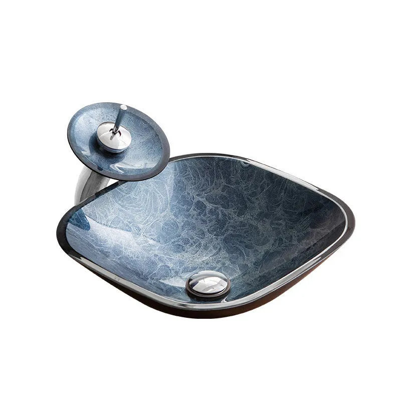 Blue grey coloured tempered glass bathroom table basin with simple art design on a countertop.