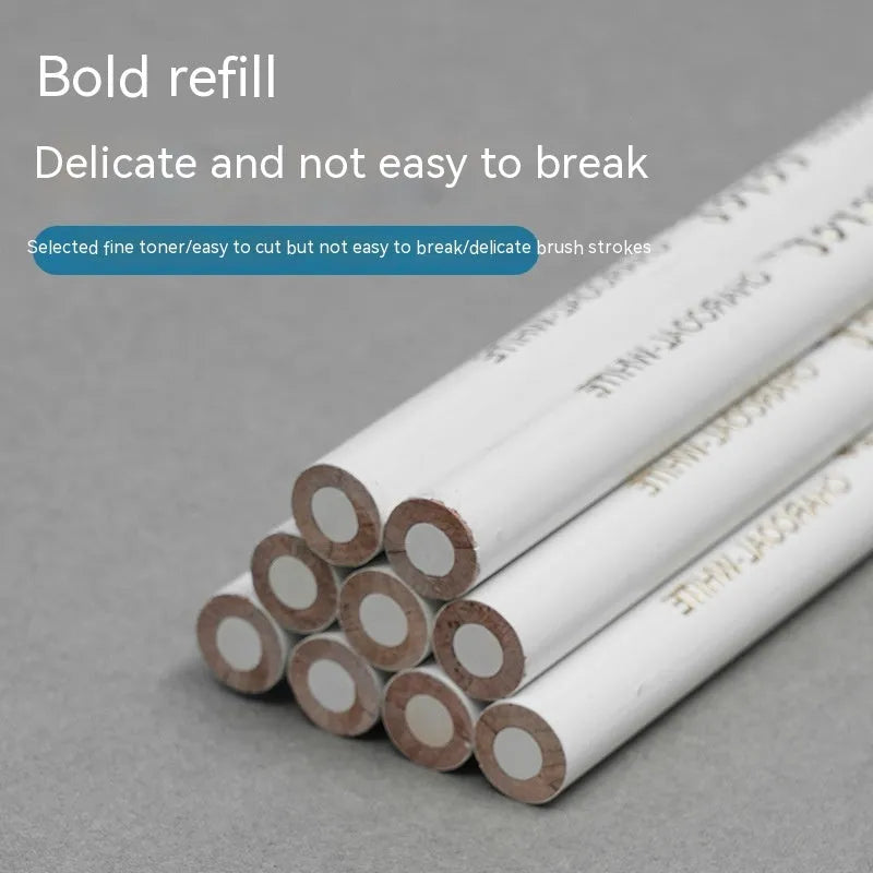 Set of three white charcoal sketching pencils in wooden casings.