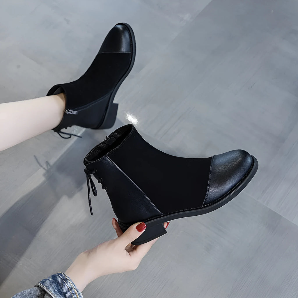 Black women's knee-high Martin boots with a side zip and decorative bow.