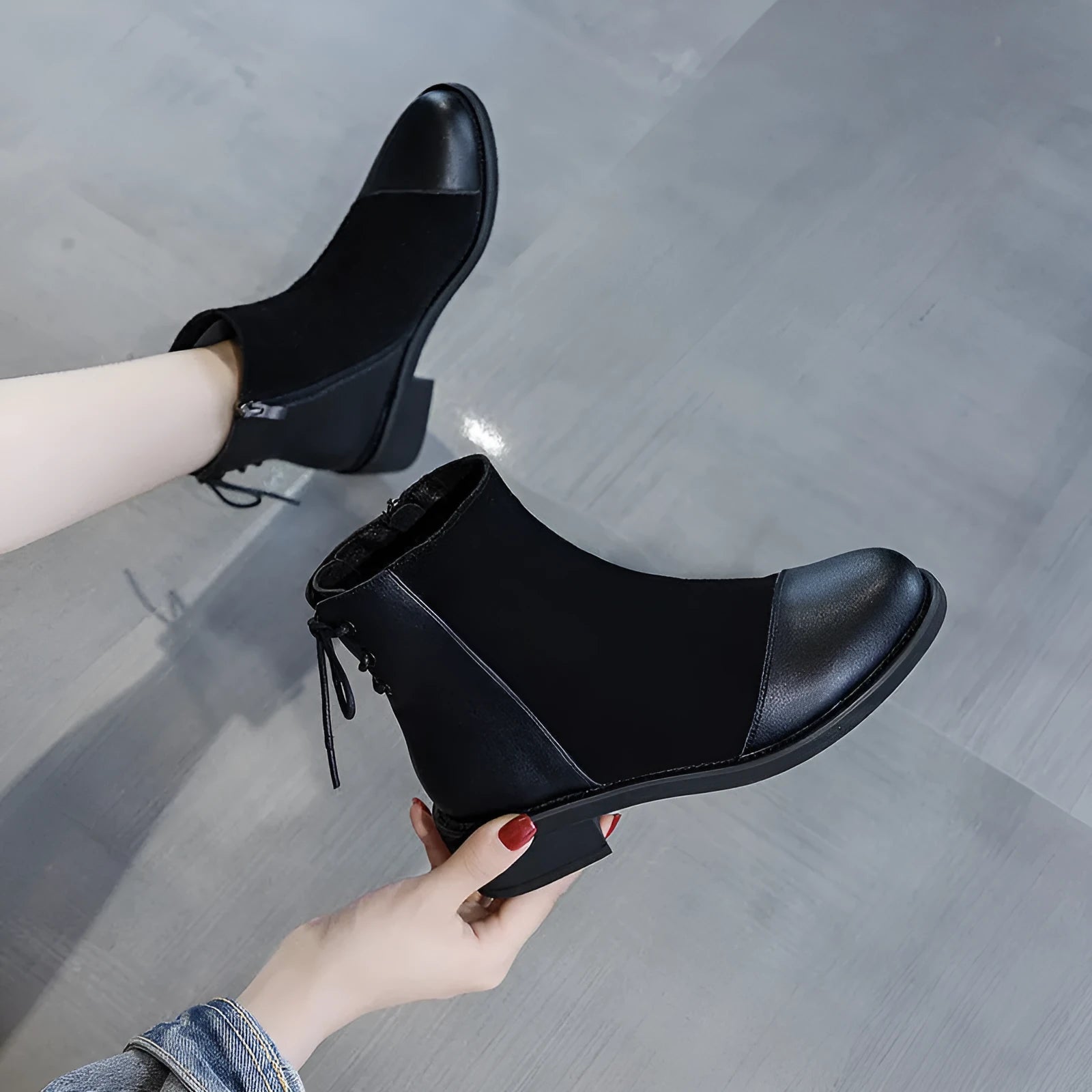 Black women's knee-high Martin boots with a side zip and decorative bow.