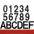 Stainless steel adhesive house number with 7.5cm black characters showing sample numbers and letters