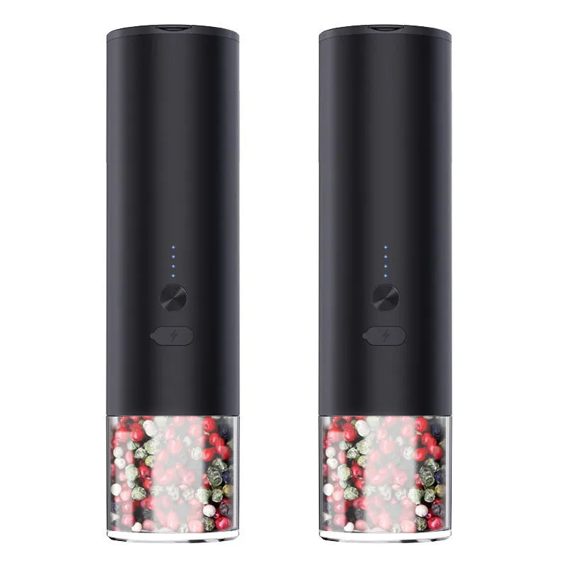 White electric salt and pepper grinder set with clear glass jar and stainless steel top on kitchen counter