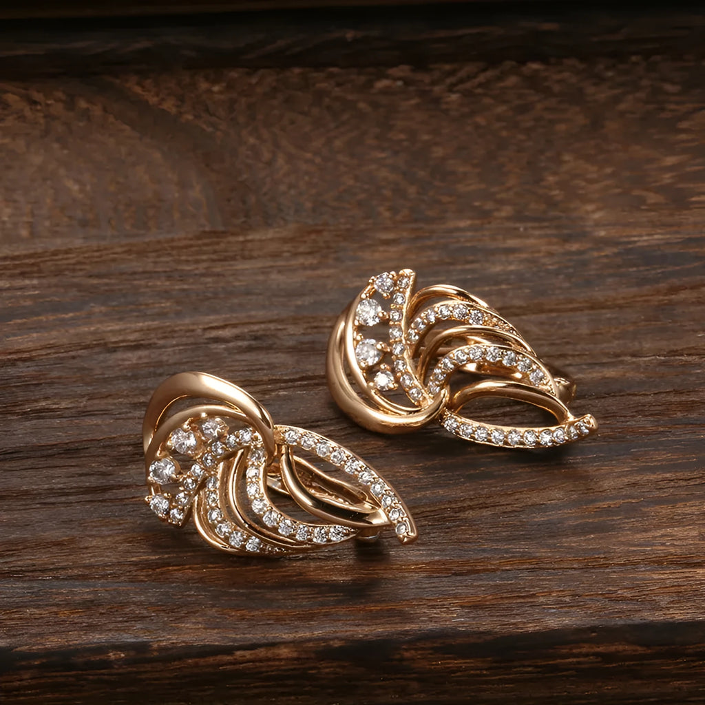 Gold-plated copper women's ear clips with wing design and micro inlaid zircon stones.