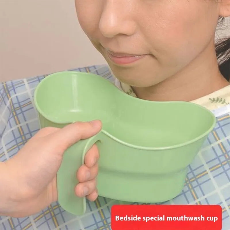 Green plastic nursing care gargle cup for bedridden patient oral hygiene.
