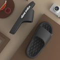 Pair of simple EVA slippers in black on a light background
