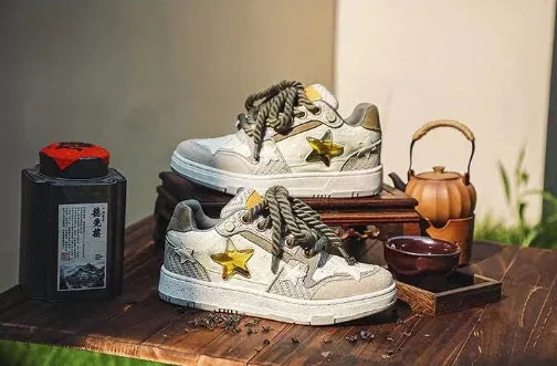 Green low-top casual sneakers with star pattern stitching and a white rubber sole.