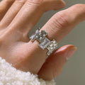 Silver plated open ring with cross design and zircon crystals.