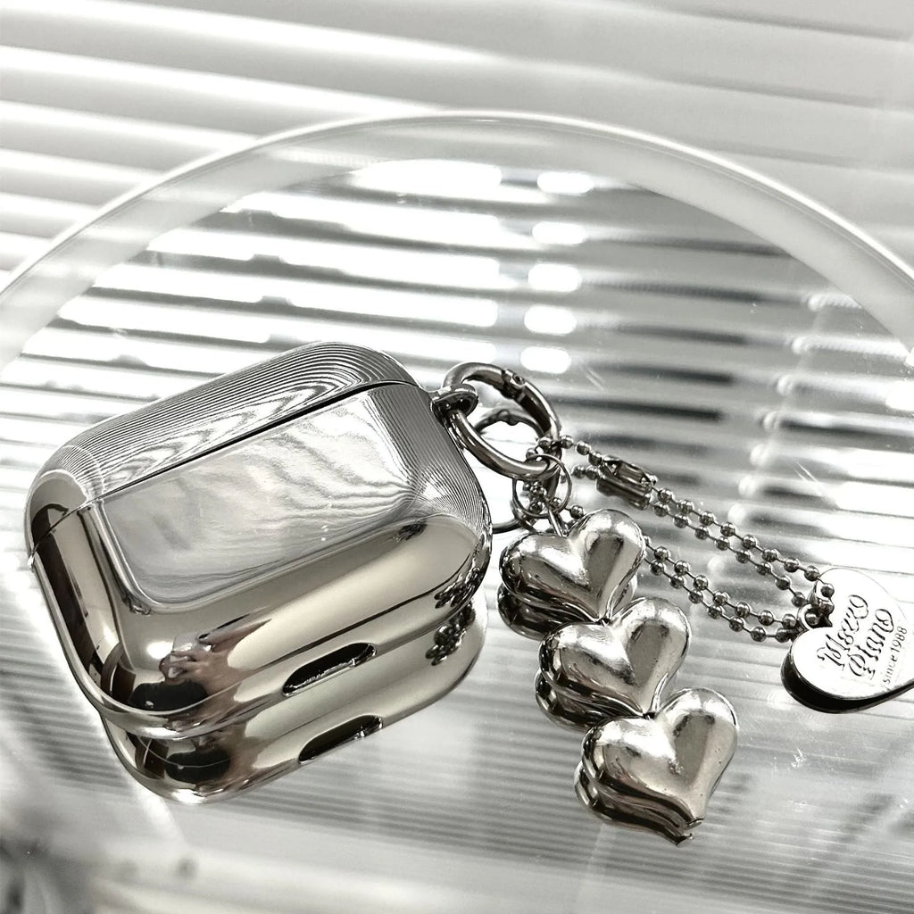 Electroplated solid colour TPU headphone case with heart pendant charms and chain for Apple earbuds.