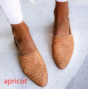 A pair of pointed toe, baotou flat sandals with a central buckle fastening, shown in a selection of colours.