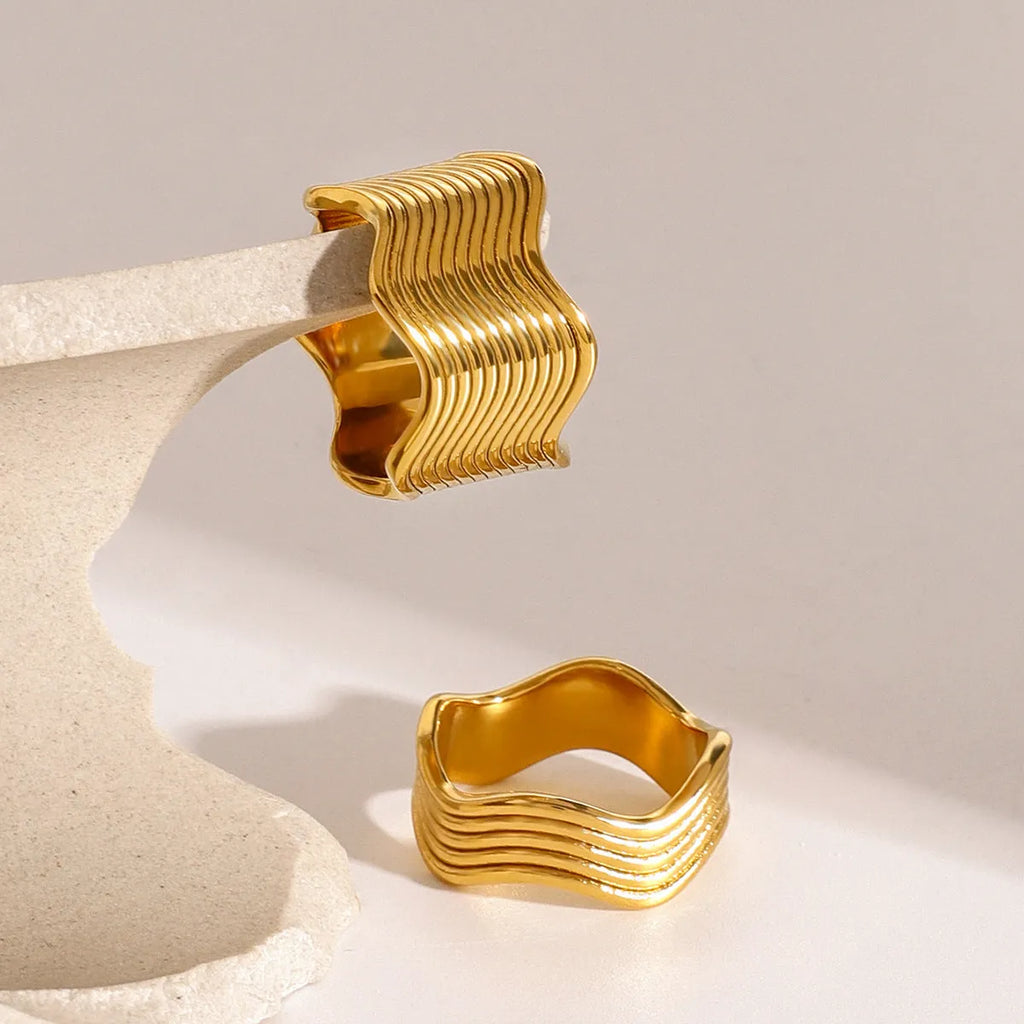 Stainless steel wide band ring with geometric wave pattern and polished electroplated finish