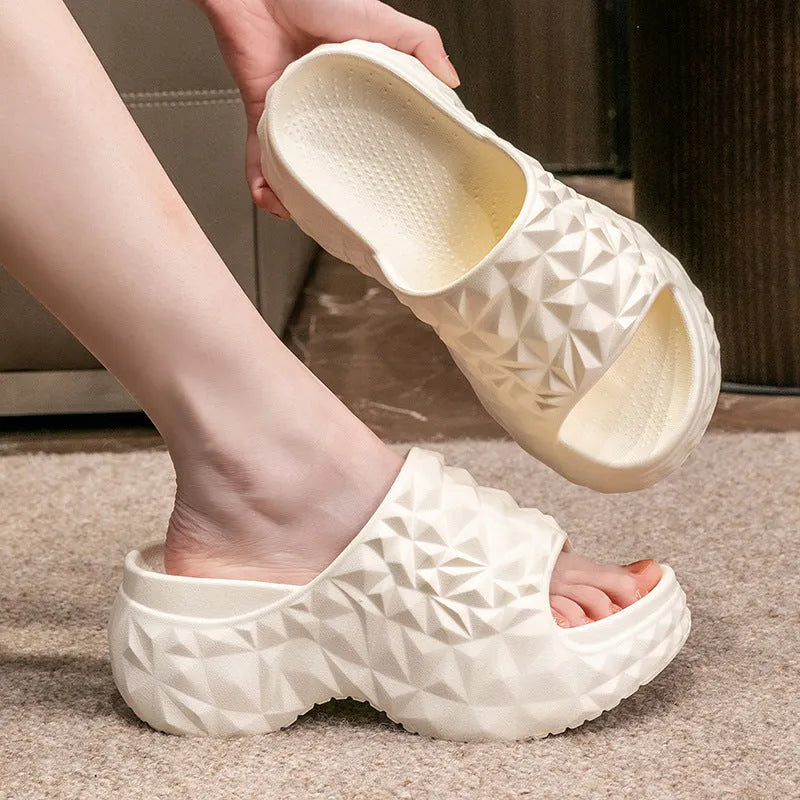 A pair of khaki high heel flip flop slippers made from injection moulded EVA with a thick sole.