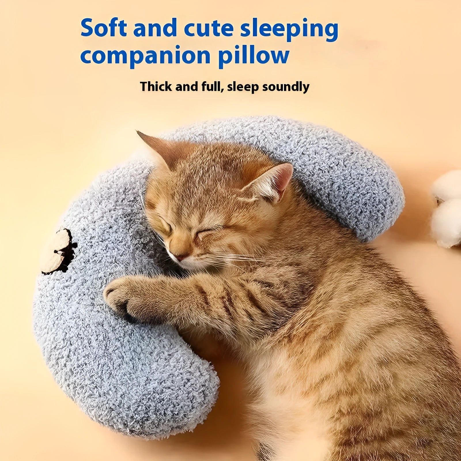 Blue U-shaped question mark cat pillow on a carpet, showing its contoured neck support design.