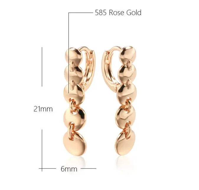 A pair of long, round circle-shaped retro earrings in a gold colour, made from woven copper