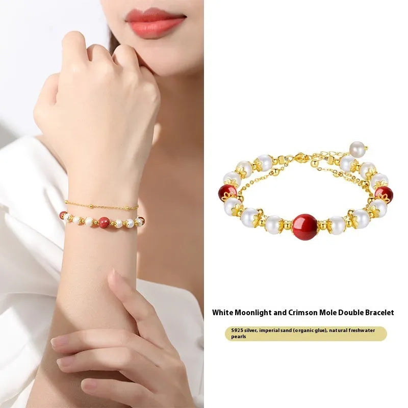 Sterling silver double-layer bracelet with white freshwater pearls and red cinnabar bean charms