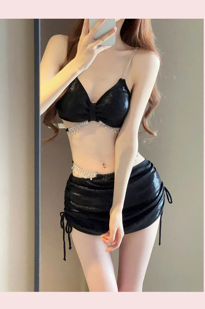Women's solid colour polyester bikini swimsuit set in black or pink on mannequin
