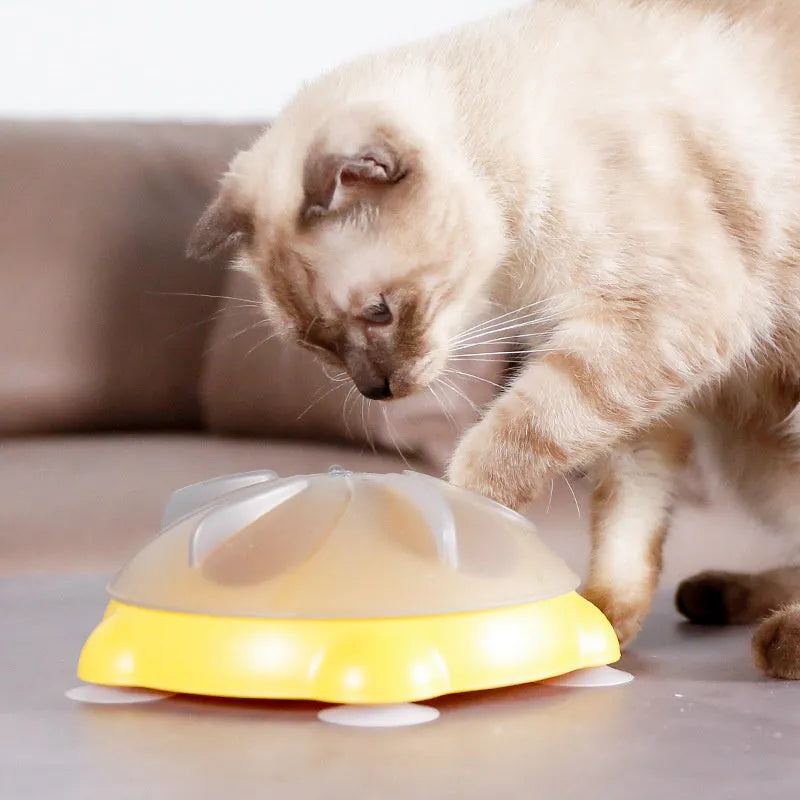 Yellow interactive pet puzzle feeder bowl with ridges and treat compartments on a white background.
