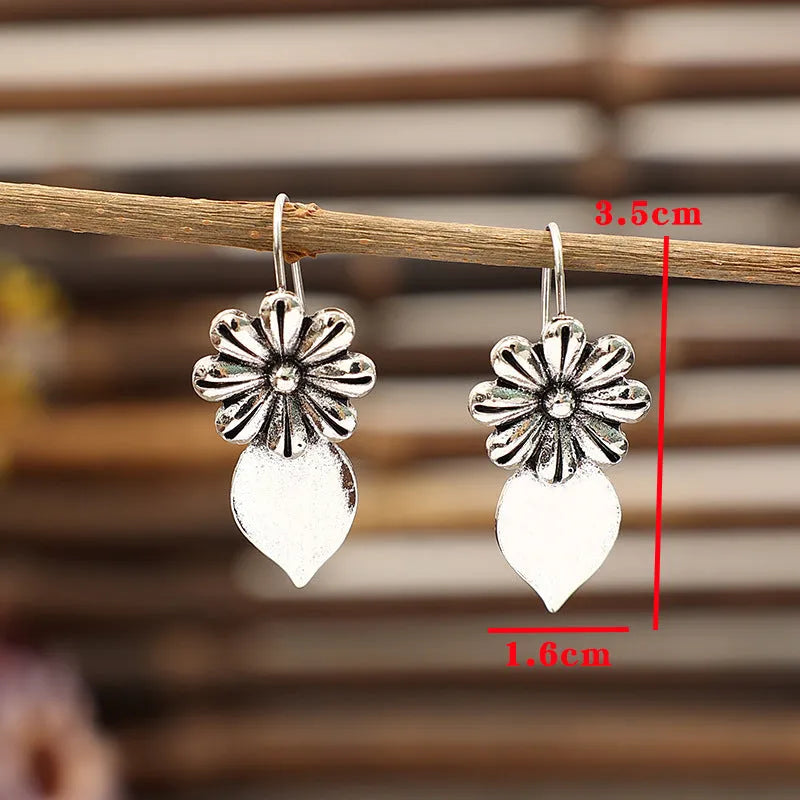 Silver alloy clip-on earrings with artificial gemstone inlays, vintage floral style, sold as a pair