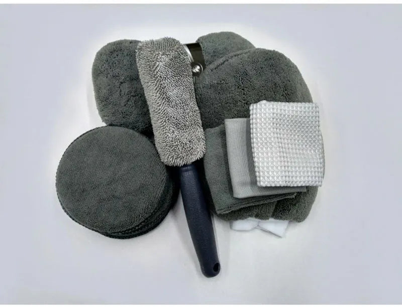 9-piece car wash cleaning kit with polyamide towels, sponge, tyre brush, and waxing cakes in dark grey and orange