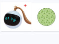 Green cloth cat toy hunting cover with USB-powered balls on a flat surface