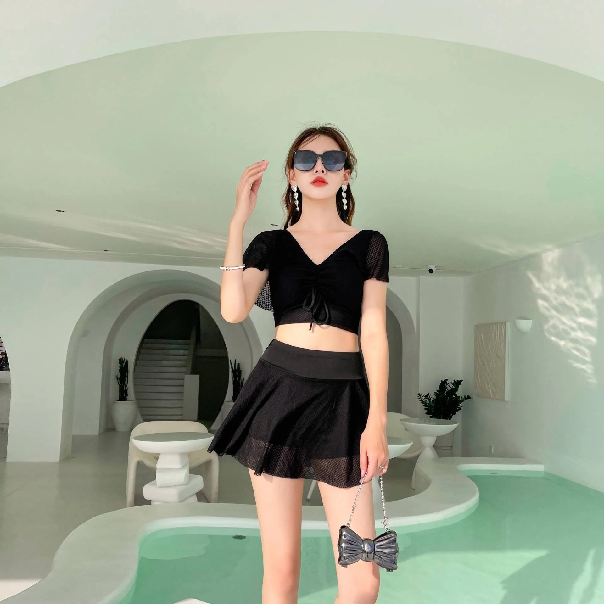 Women's solid colour two-piece swimsuit with a skirted bottom in white, black, or pink.