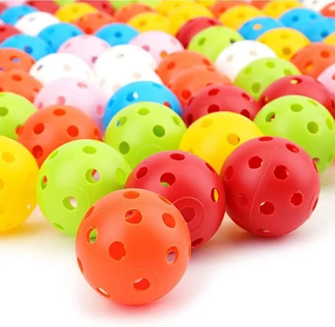 Multi-colour golf practice balls with 26-hole design next to a net storage bag