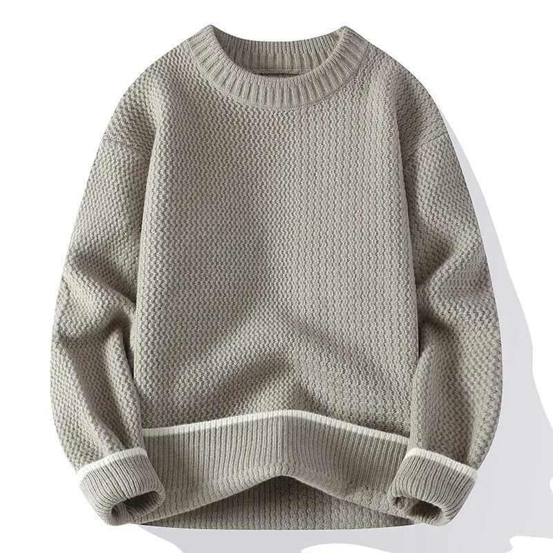 Man wearing a grey loose-fit round neck men's pullover sweater.