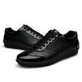 Genuine leather casual men's shoes in black with lace-up closure on a plain background