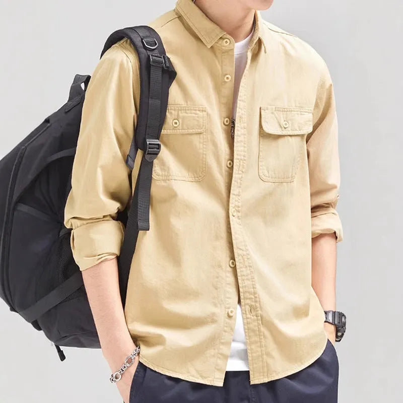 Man wearing a loose-fit light grey long sleeve cardigan-style shirt made from polyester.