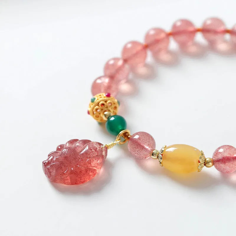 Close-up of a women's crystal beaded bracelet with a nine tail fox charm on a model's wrist.