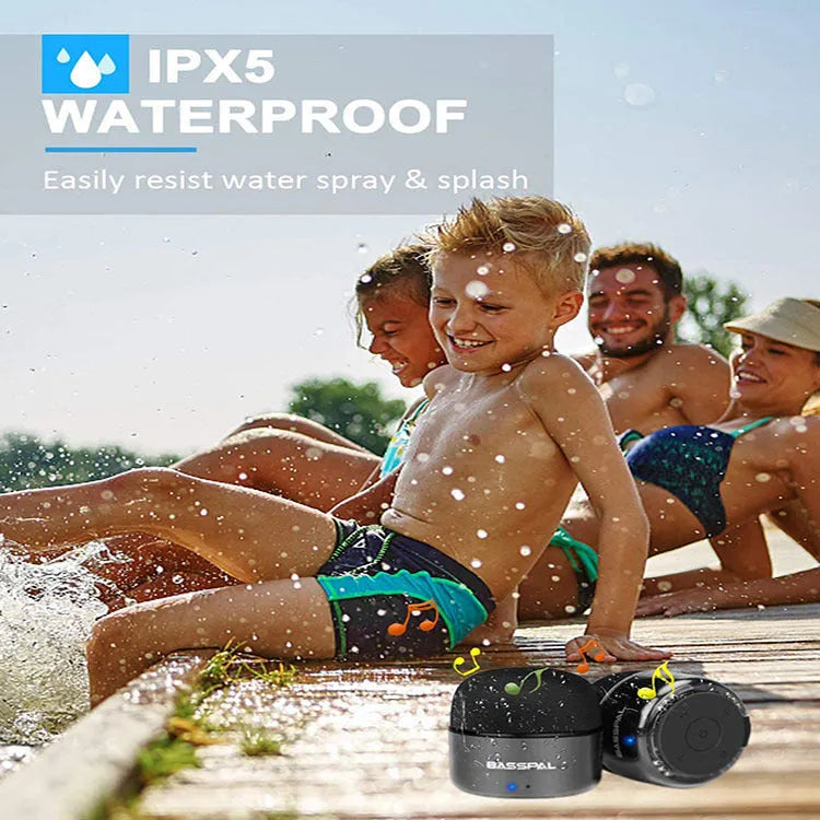 A small black plastic waterproof portable Bluetooth speaker with control buttons.