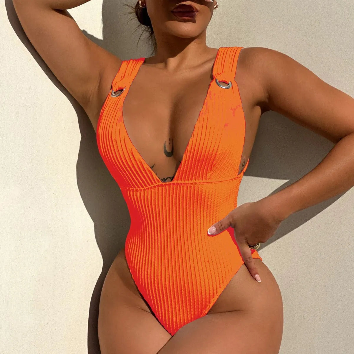 Women's solid colour one-piece swimsuit in black, white, green, or orange.