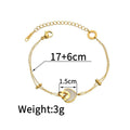 Close-up of a women's stainless steel bracelet with a double-layered heart pendant.