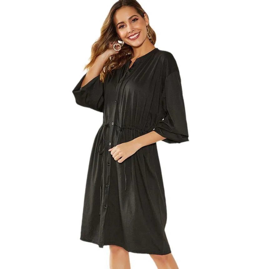 Black solid colour A-line midi dress with an elastic waist, long sleeves, and an attached belt.