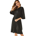 Black solid colour A-line midi dress with an elastic waist, long sleeves, and an attached belt.