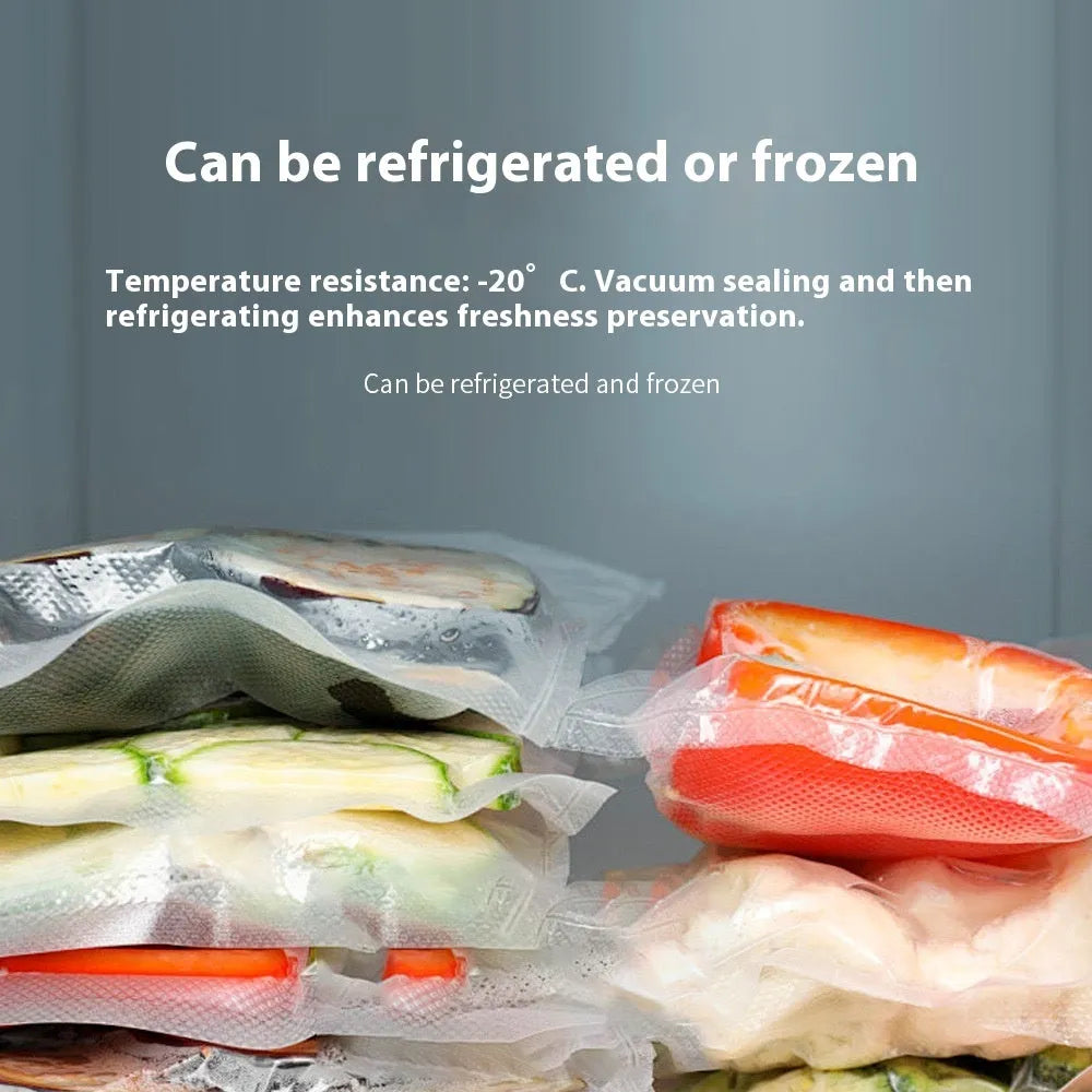 USB electric vacuum sealer pump with reusable food storage envelope bags on a kitchen counter