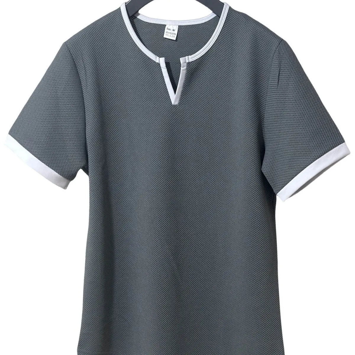 Colour-block waffle textured V-neck sports t-shirt in polyester on a size chart.
