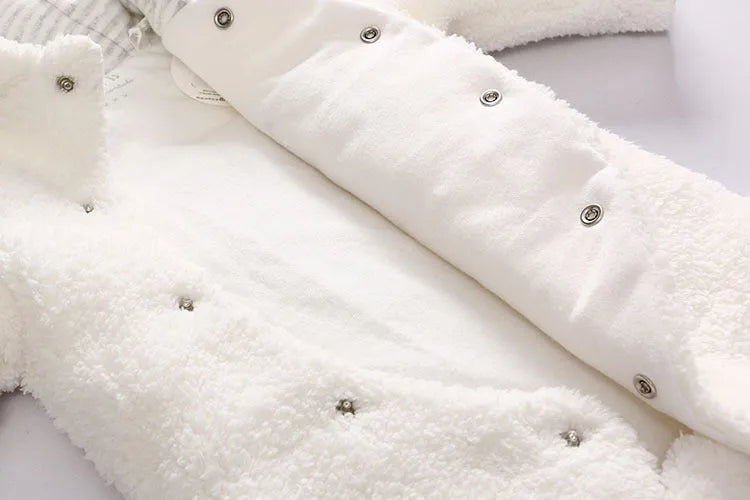 Baby wearing a cosy white cotton padded lamb-themed winter bodysuit with long sleeves.