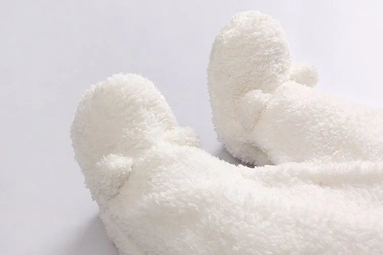 Baby wearing a cosy white cotton padded lamb-themed winter bodysuit with long sleeves.