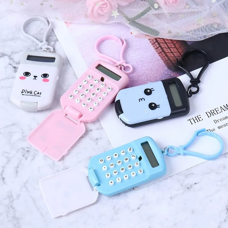 Cookie-shaped mini calculator with key ring in pink, blue, grey, or black, 6.4 x 3.6 x 11.2 cm plastic body